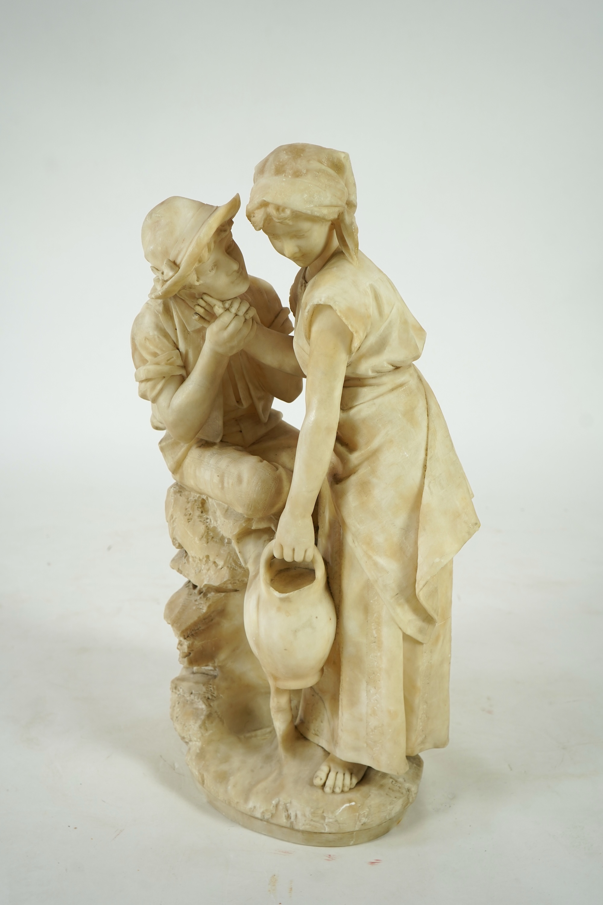 A large Continental alabaster group of a peasant couple, late 19th / early 20th century